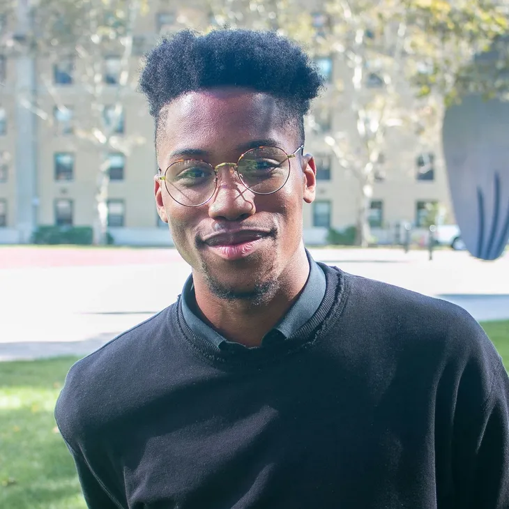 A man in front of the office